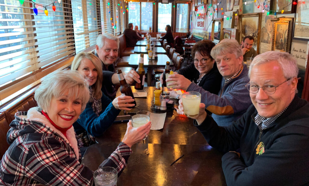 group of people sitting around table with drinks on the Chicago pub tour