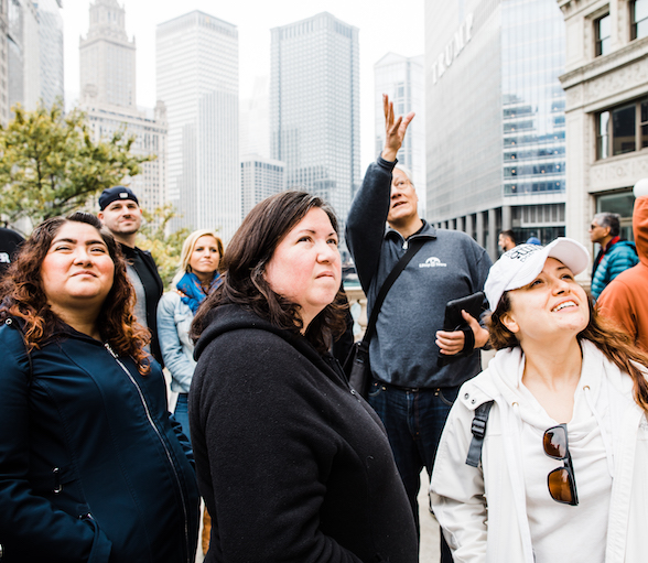 Tourists on downtown tour of Chicago looking at skyscrapers